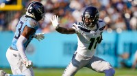 Seattle Seahawks wide receiver Jaxon Smith-Njigba (11) throws the stiff arm to Tennessee Titans safety Kevin Winston Jr. (23) during the second quarter at Nissan Stadium in Nashville, Tenn., Sunday, Nov. 23, 2025.
