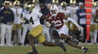 Notre Dame Fighting Irish running back Jeremiyah Love (4) runs with the football during the first quarter against Stanford Cardinal safety Che Ojarikre (22) at Stanford Stadium. Mandatory Credit: Stan Szeto-Imagn Images