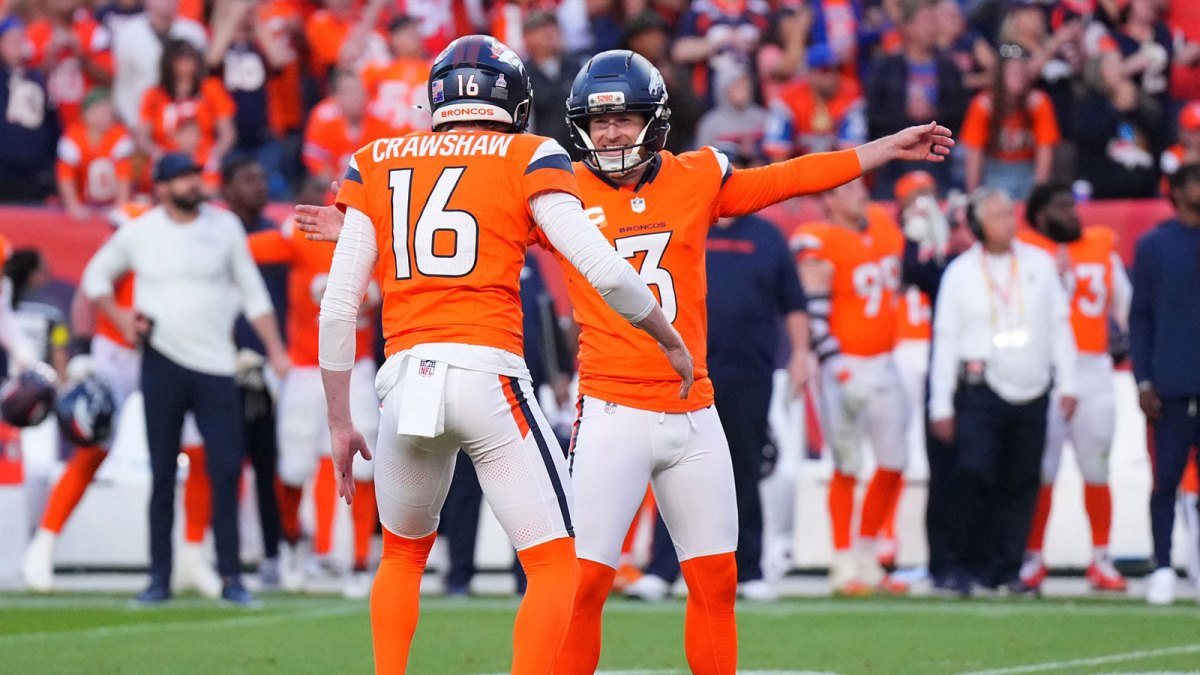 Denver Broncos punter Jeremy Crawshaw (16) and Denver Broncos kicker Wil Lutz (3) celebrate the win against the New York Giants at Empower Field at Mile High.