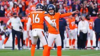 Denver Broncos punter Jeremy Crawshaw (16) and Denver Broncos kicker Wil Lutz (3) celebrate the win against the New York Giants at Empower Field at Mile High.