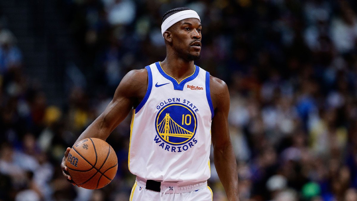 Golden State Warriors forward Jimmy Butler III (10) dribbles the ball up court in the first quarter against the Denver Nuggets at Ball Arena.