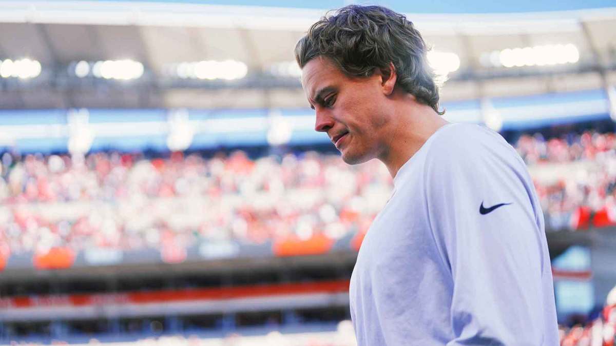 Injured Cincinnati Bengals quarterback Joe Burrow (9) walks onto the field before the first quarter against the New England Patriots at Paycor Stadium.