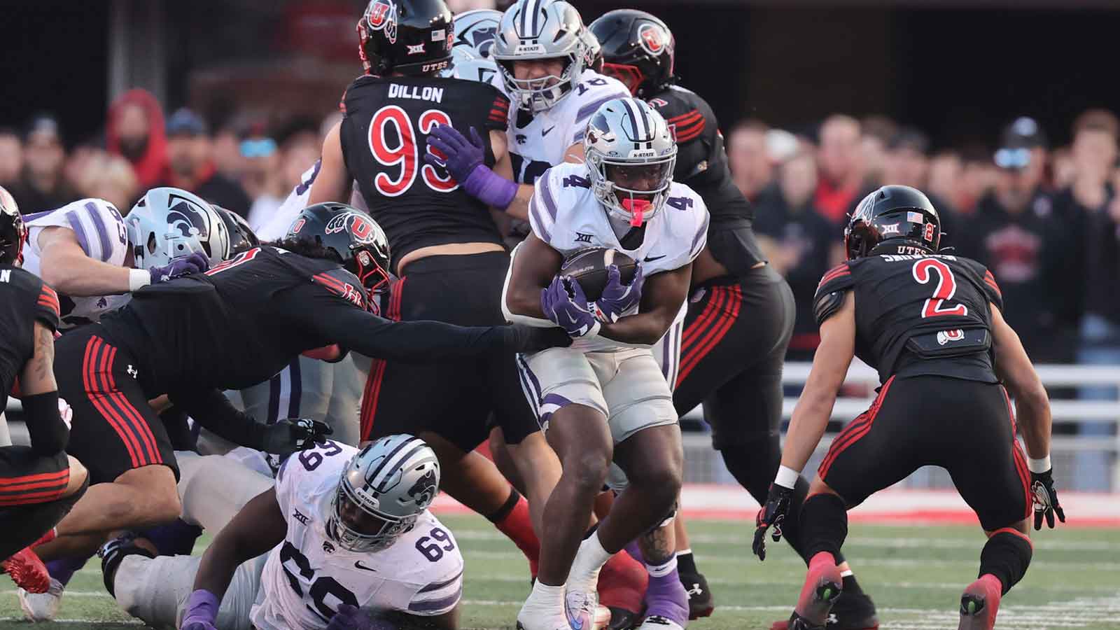 Kansas State Wildcats running back Joe Jackson (4) runs against Utah Utes cornerback Smith Snowden (2) during the second half at Rice-Eccles Stadium.