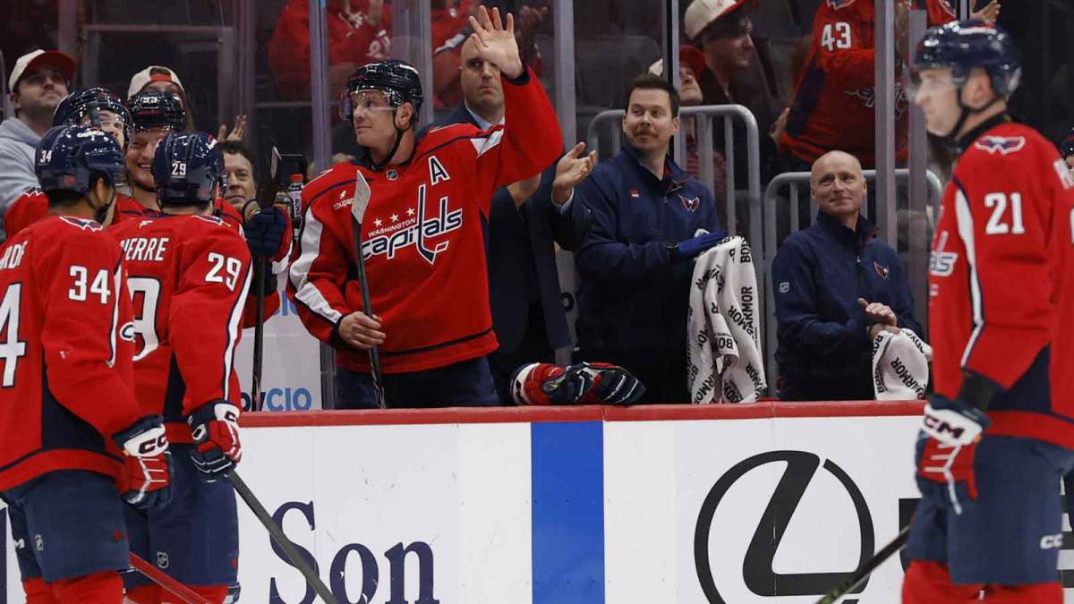 Washington Capitals defenseman John Carlson (74) waves to fans while being acknowledged for reaching number two in all-time games played for the Capitals during a timeout against the Los Angeles Kings during the first period at Capital One Arena.