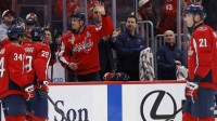 Washington Capitals defenseman John Carlson (74) waves to fans while being acknowledged for reaching number two in all-time games played for the Capitals during a timeout against the Los Angeles Kings during the first period at Capital One Arena.