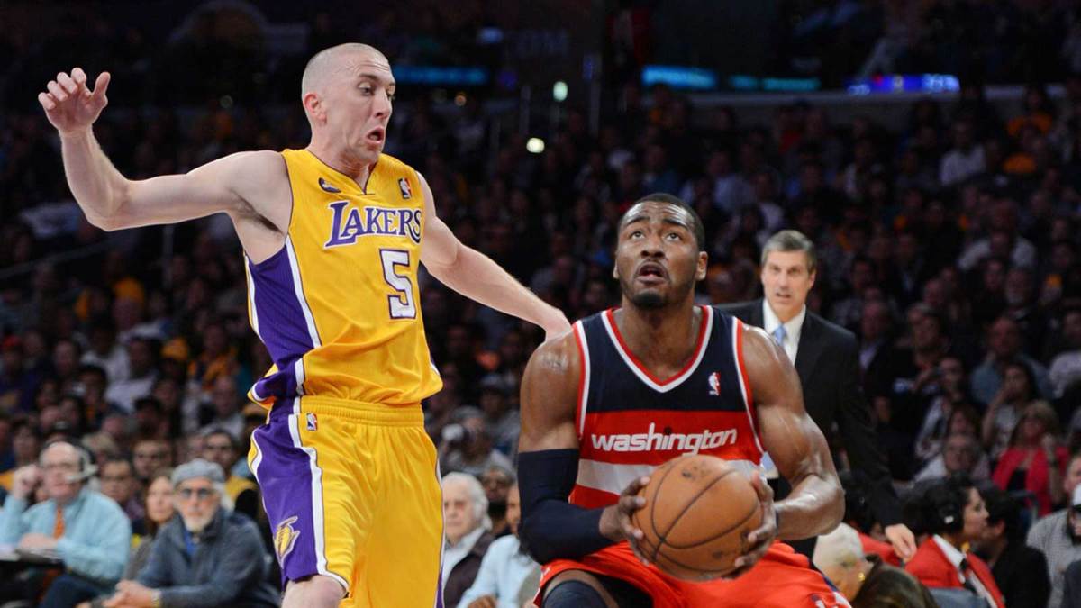 Los Angeles Lakers point guard Steve Blake (5) guards Washington Wizards point guard John Wall (2) during the game at the Staples Center. Wizards won 103-100.