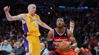 Los Angeles Lakers point guard Steve Blake (5) guards Washington Wizards point guard John Wall (2) during the game at the Staples Center. Wizards won 103-100.