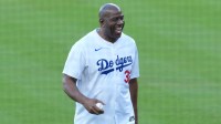 Los Angeles Dodgers co owner Magic Johnson reacts before throwing the ceremonial first pitch before game five of the 2025 MLB World Series between the Toronto Blue Jays and the Los Angeles Dodgers at Dodger Stadium.