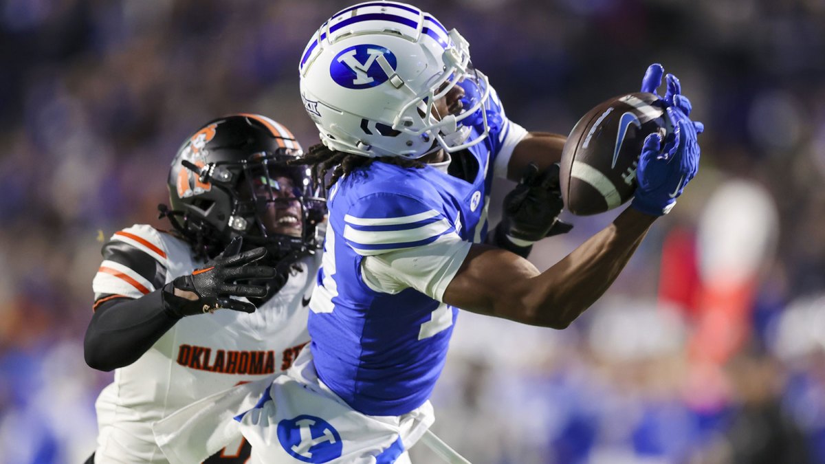 Brigham Young Cougars wide receiver Jojo Phillips (13) attempts to catch a pass against Oklahoma State Cowboys cornerback Cam Smith (3) during the first quarter at LaVell Edwards Stadium.
