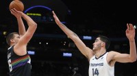Denver Nuggets center Nikola Jokic (15) shoots as Memphis Grizzlies center Zach Edey (14) defends during the first quarter at FedExForum.