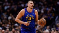 Denver Nuggets center Nikola Jokic (15) controls the ball in the first quarter against the San Antonio Spurs at Ball Arena.