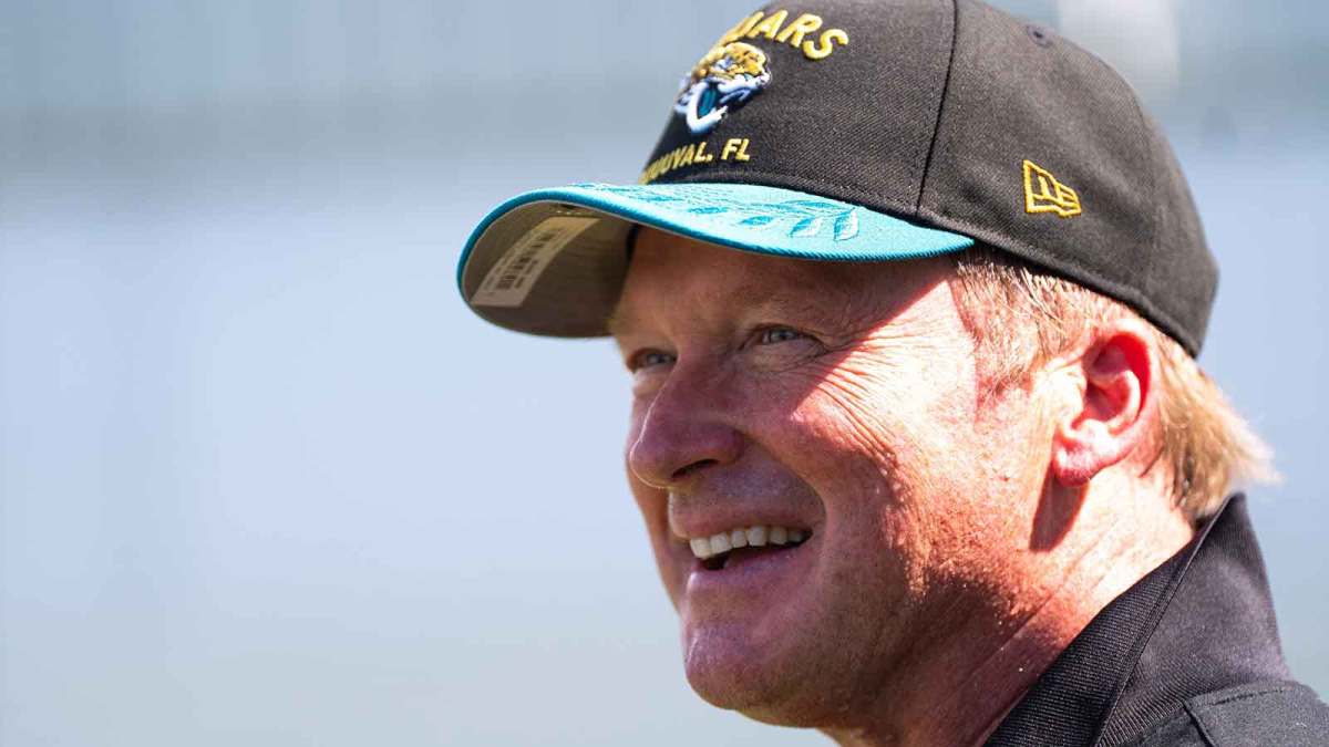 Former NFL Coach Jon Gruden have a laugh while attending an NFL training camp session ten at the Miller Electric Center, Tuesday, Aug. 5, 2025, in Jacksonville, Fla.