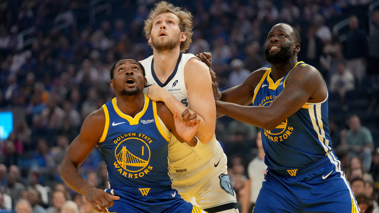 Golden State Warriors forward Jonathan Kuminga (1) and forward Draymond Green (23) battle for position with Memphis Grizzlies center Jock Landale (31) in the first quarter at the Chase Center.