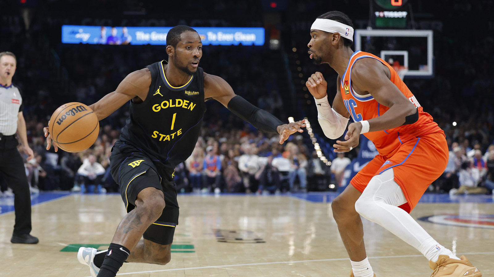 Golden State Warriors forward Jonathan Kuminga (1) moves the ball down the court beside Oklahoma City Thunder guard Shai Gilgeous-Alexander (2) during the second half at Paycom Center.