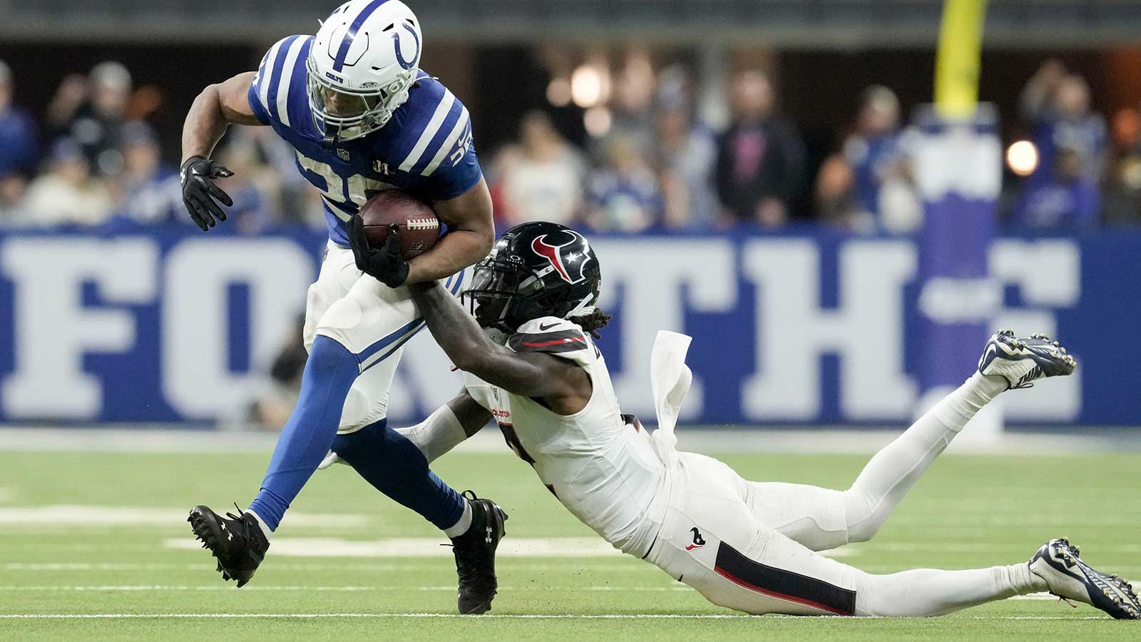 Houston Texans safety Calen Bullock (2) brings down Indianapolis Colts running back Jonathan Taylor (28