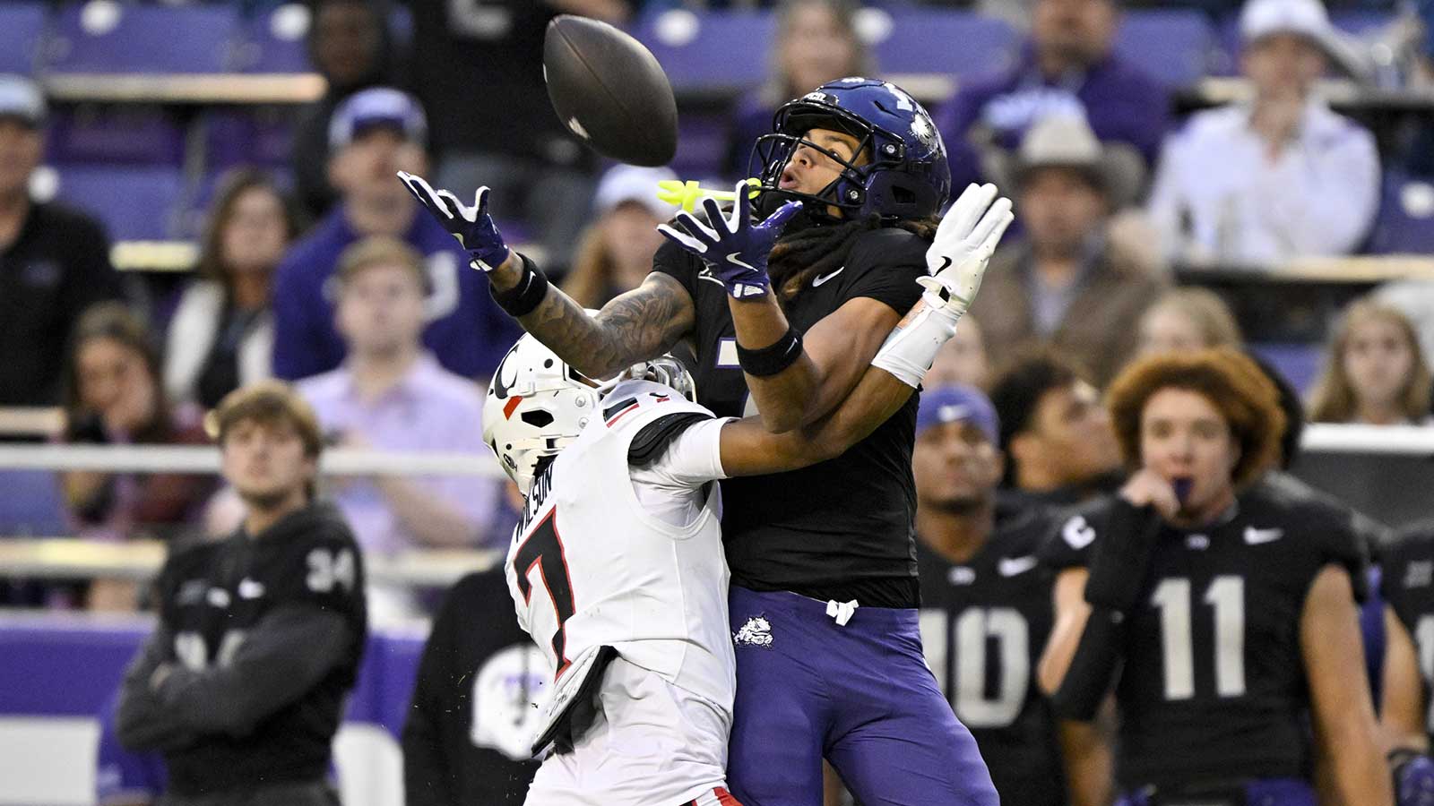 TCU Horned Frogs wide receiver Jordan Dwyer (7) catches a pass over Cincinnati Bearcats cornerback Logan Wilson (7) and runs for a touchdown during the first half at Amon G. Carter Stadium.