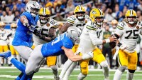 Detroit Lions defensive end Aidan Hutchinson (97) tackles Green Bay Packers quarterback Jordan Love (10) during the first half at Ford Field in Detroit on Thursday, Nov. 27, 2025