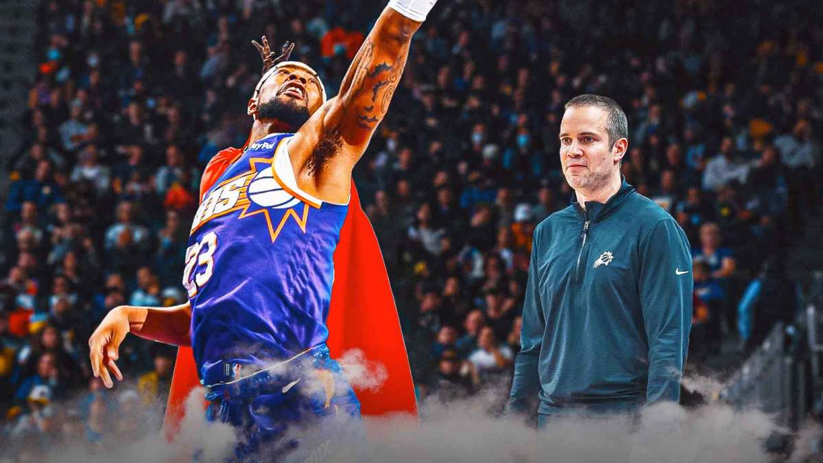 Jordan Goodwin in a Phoenix Suns jersey, grabbing a rebound, but Goodwin also has a Superman cape on the back of him, with Suns head coach Jordan Ott smiling.