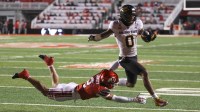 Arizona State Sun Devils wide receiver Jordyn Tyson (0) runs for a touchdown against Utah Utes cornerback Smith Snowden (2) during the third quarter at Rice-Eccles Stadium.