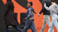 Nov 2, 2025; Cincinnati, Ohio, USA; American gymnast Simone Biles walks on the field before the game between the Chicago Bears and the Cincinnati Bengals at Paycor Stadium. Mandatory Credit: Joseph Maiorana-Imagn Images