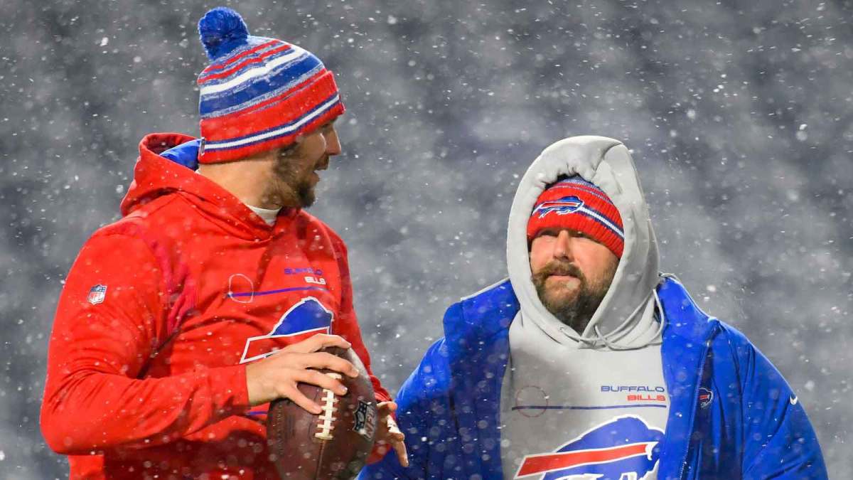 Buffalo Bills quarterback Josh Allen (left) talks with offensive coordinator Brian Daboll (right) in a snow storm prior to the game against the New England Patriots at Highmark Stadium.