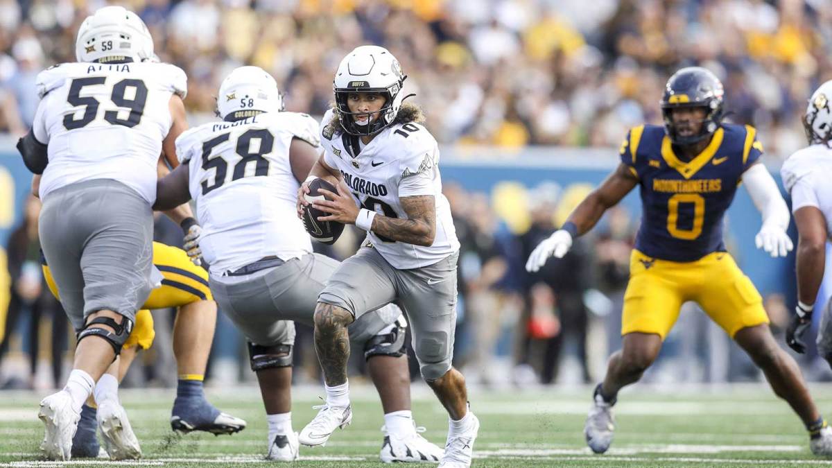Colorado Buffaloes quarterback Julian Lewis (10) runs out of the pocket during the third quarter against the West Virginia Mountaineers at Milan Puskar Stadium.