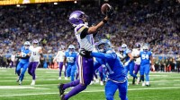 Minnesota Vikings wide receiver Justin Jefferson (18) makes a catch for a touchdown against Detroit Lions cornerback Amik Robertson (21) during the first half at Ford Field in Detroit on Sunday, November 2, 2025.