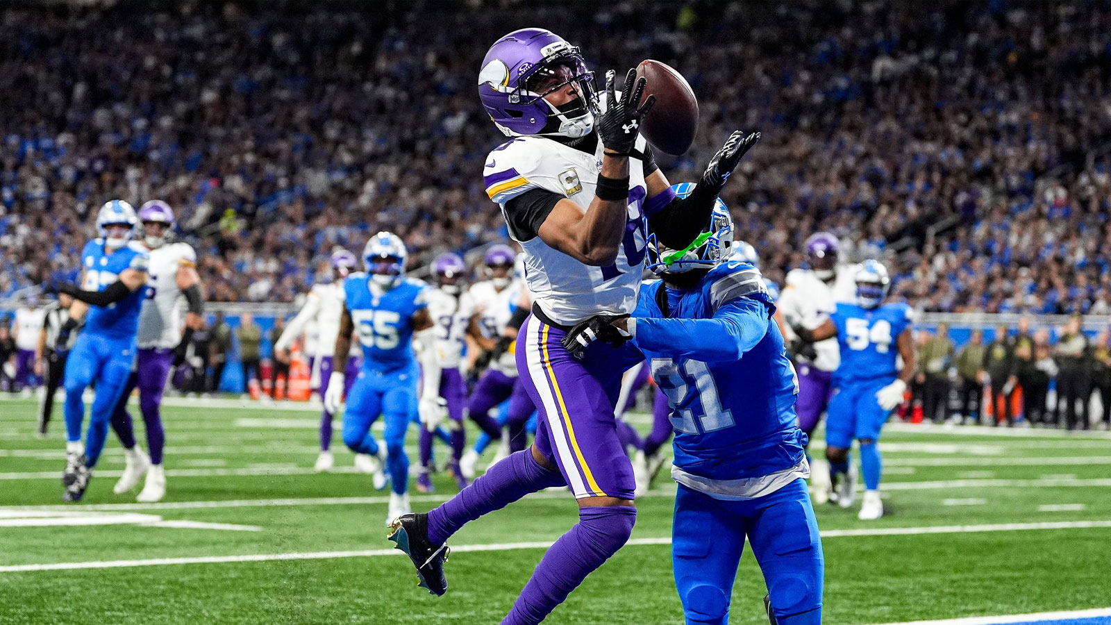 Minnesota Vikings wide receiver Justin Jefferson (18) makes a catch for a touchdown against Detroit Lions cornerback Amik Robertson (21) during the first half at Ford Field in Detroit on Sunday, November 2, 2025.