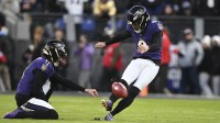 Baltimore Ravens place kicker Justin Tucker (9) kicks off as punter Jordan Stout (11) holds during the first quarter against the Cleveland Browns at M&T Bank Stadium.