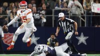Kansas City Chiefs quarterback Patrick Mahomes (15) escapes the pressure from Dallas Cowboys defensive end Donovan Ezeiruaku (41) during the fourth quarter at AT&T Stadium.