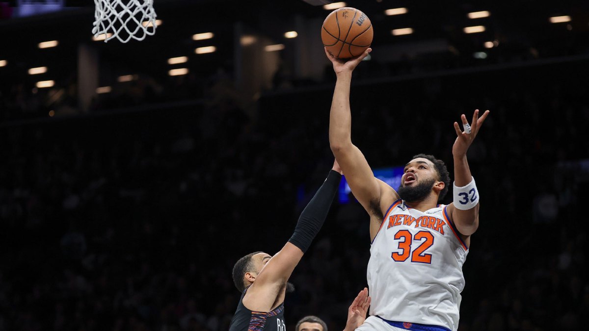 New York Knicks center Karl-Anthony Towns (32) shoots the ball as Brooklyn Nets guard Tyrese Martin (13) defends during the first half at Barclays Center.