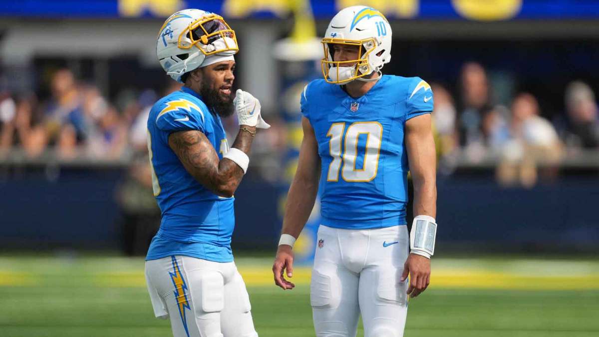 Los Angeles Chargers quarterback Justin Herbert (10) talks with wide receiver Keenan Allen (13) against the Los Angeles Rams in the first half at SoFi Stadium.