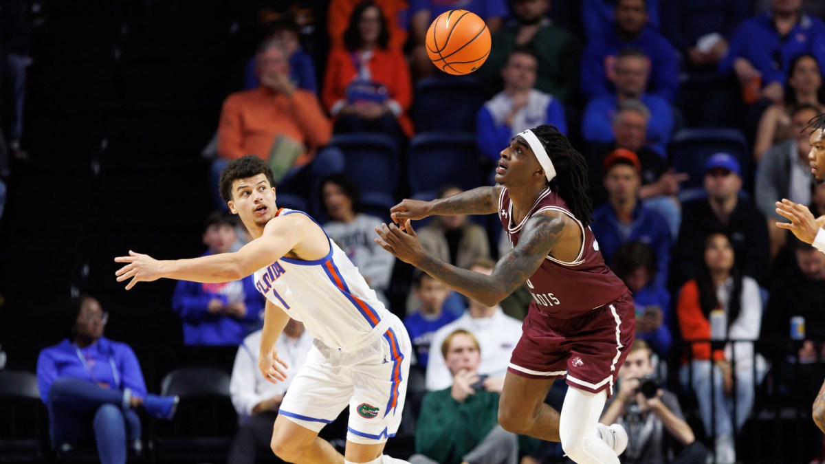 Florida Gators guard Walter Clayton Jr. (1) and Southern Illinois Salukis guard Kennard Davis Jr. (30) battle for a loose ball during the second half at Exactech Arena at the Stephen C. O'Connell Center.