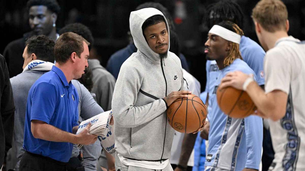 Memphis Grizzlies guard Ja Morant (center) looks on from the team bench during the first quarter against the Dallas Mavericks at the American Airlines Center. Mandatory Credit: Jerome Miron-Imagn Images