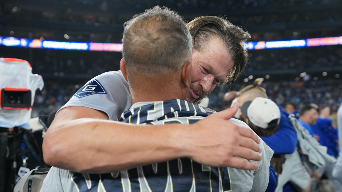 Los Angeles Dodgers pitcher Clayton Kershaw (22) reacts with manager Dave Roberts (30) after defeating the Toronto Blue Jays in the eleventh inning for game seven of the 2025 MLB World Series at Rogers Centre.