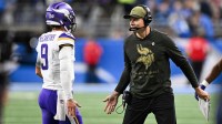 Minnesota Vikings head coach Kevin O'Connell greets quarterback J.J. McCarthy (9) after throwing a touchdown pass in the first quarter at Ford Field.