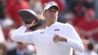 Mississippi Rebels head coach Lane Kiffin throws the ball prior to the game against the Georgia Bulldogs at Sanford Stadium