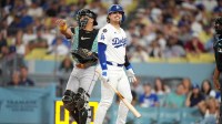 Los Angeles Dodgers third baseman Kike Hernandez (8) reacts after striking out in the third inning as Arizona Diamondbacks catcher James McCann (8) watches at Dodger Stadium.