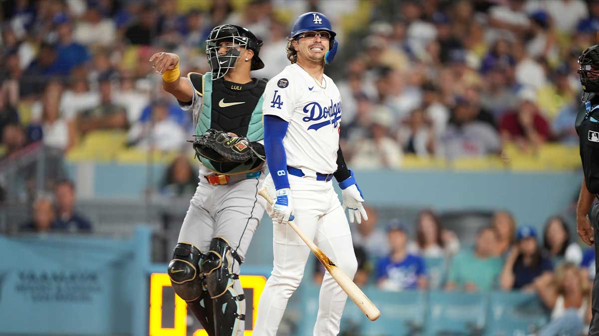 Los Angeles Dodgers third baseman Kike Hernandez (8) reacts after striking out in the third inning as Arizona Diamondbacks catcher James McCann (8) watches at Dodger Stadium.