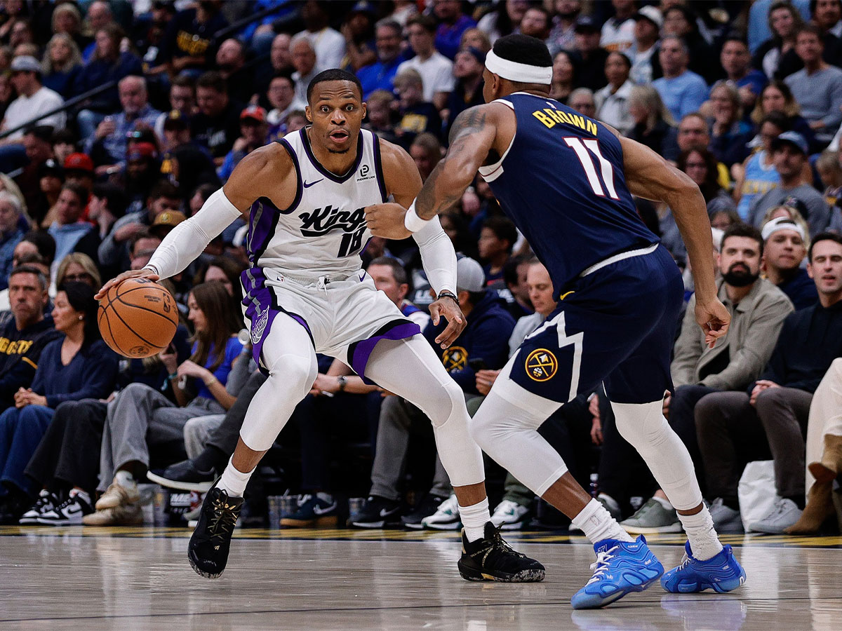 Sacramento Kings guard Russell Westbrook (18) controls the ball as Denver Nuggets guard Bruce Brown (11) guards in the third quarter at Ball Arena.
