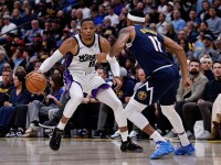 Sacramento Kings guard Russell Westbrook (18) controls the ball as Denver Nuggets guard Bruce Brown (11) guards in the third quarter at Ball Arena.