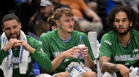 Dallas Mavericks guard Klay Thompson (31) and forward Cooper Flagg (32) and center Dereck Lively II (2) look on from the team bench during the game between the Mavericks and the Raptors at the American Airlines Center.