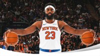 Mitchell Robinson Knicks #23 with arms outstretched and a basketball in each arm