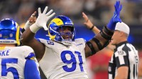 Los Angeles Rams defensive end Kobie Turner (91) celebrates after a sack of Tampa Bay Buccaneers quarterback Baker Mayfield (6) in the first half at SoFi Stadium.