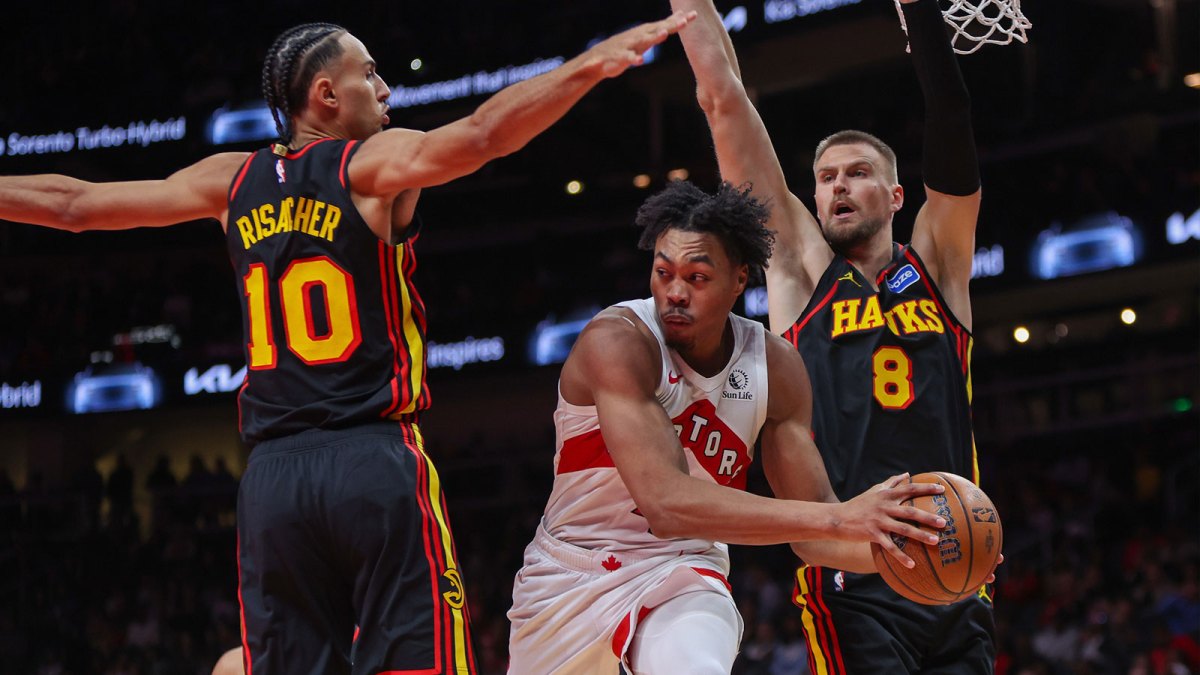 Toronto Raptors forward Scottie Barnes (4) passes around Atlanta Hawks forward Zaccharie Risacher (10) and center Kristaps Porzingis (8) in the fourth quarter at State Farm Arena.