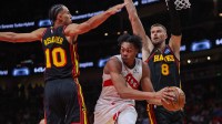 Toronto Raptors forward Scottie Barnes (4) passes around Atlanta Hawks forward Zaccharie Risacher (10) and center Kristaps Porzingis (8) in the fourth quarter at State Farm Arena.