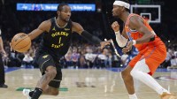 Golden State Warriors forward Jonathan Kuminga (1) moves the ball down the court beside Oklahoma City Thunder guard Shai Gilgeous-Alexander (2) during the second half at Paycom Center.