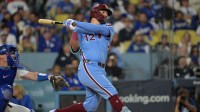 Philadelphia Phillies designated hitter Kyle Schwarber (12) hits a solo home run during the fourth inning against the Los Angeles Dodgers in game three of the NLDS during the 2025 MLB playoffs at Dodger Stadium.