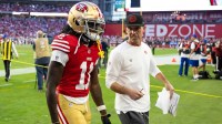 San Francisco 49ers head coach Kyle Shanahan talks to wide receiver Brandon Aiyuk (11) against the Arizona Cardinals at State Farm Stadium.