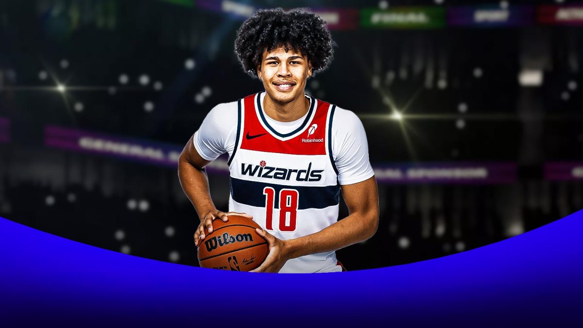 Kyshawn George smiles with basketball in hand